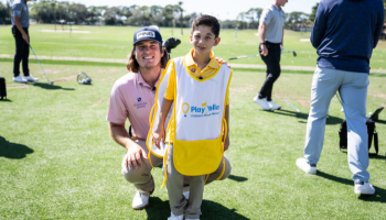 Woman handing caddy some items.
